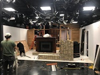 a man is working on the set of a television show