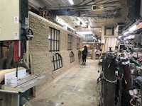 a man is working on a machine in a workshop