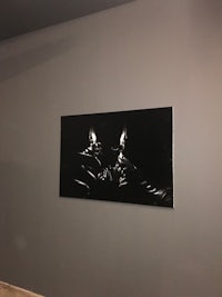 a black and white painting on the wall of a room