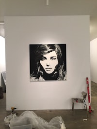 a black and white photo of a woman on a wall