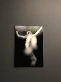 a black and white photograph hanging on a wall
