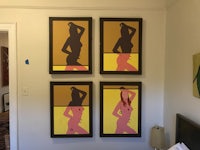 four framed portraits of a woman hanging in a bedroom
