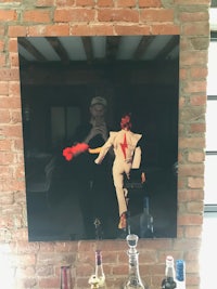 a painting of a man in a suit on a brick wall