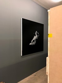 a black and white painting in an empty room